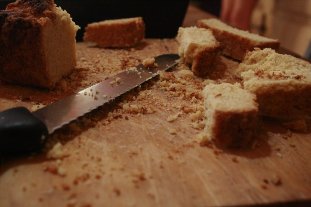 rusks on a wooden cutting board with bread knife